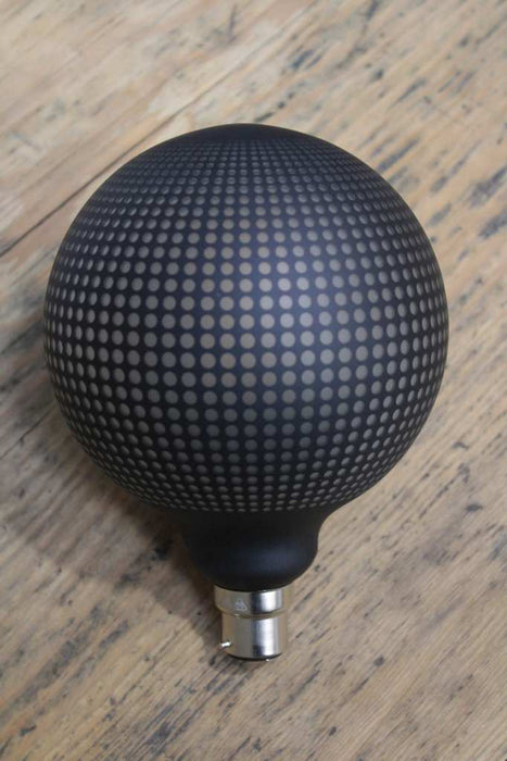 Light bulb with textured dot pattern