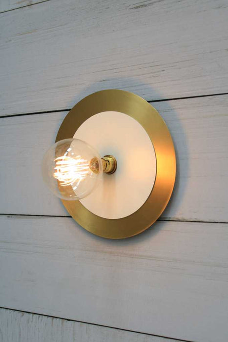 Large brass with small white disc wall light