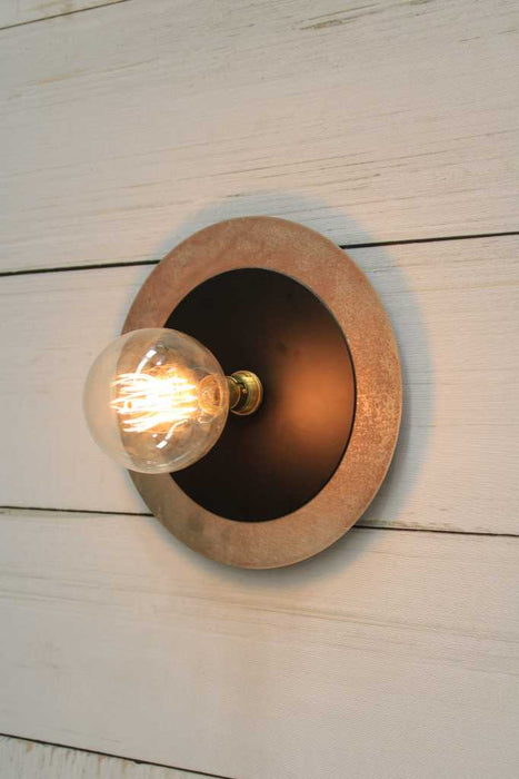 Large metal with small black disc wall light