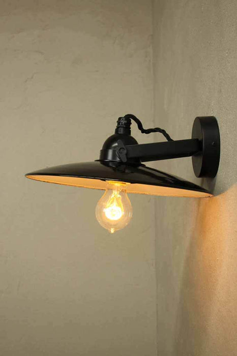 Dish wall light ideal for task lighting thanks to its poised articulated tilt arm