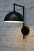 Black hook swivel arm wall light with black dome shade