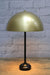 Table lamp with gold/brass dome shade and black base