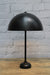 Table lamp with black dome shade and black base