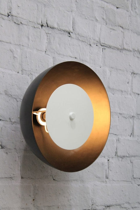 Dome wall light with black shade and white disc