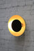 Dome wall light with gold/brass shade and black disc