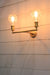 Double arm wall sconce in gold with decorative bulb