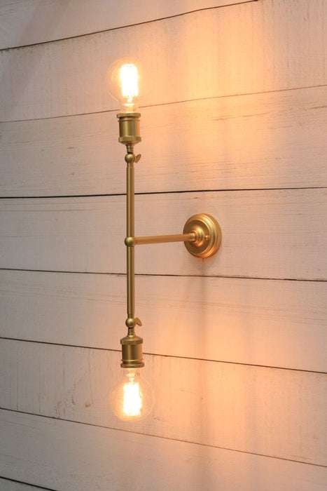 Double Arm Wall sconce in gold vertical position