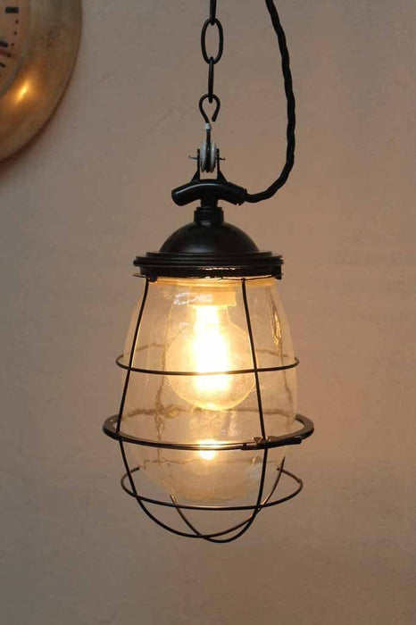 Engine room hanging light. tear drop glass shade. black cage. chain cord. glass pendant lights for cafe bars and restaurant lighting