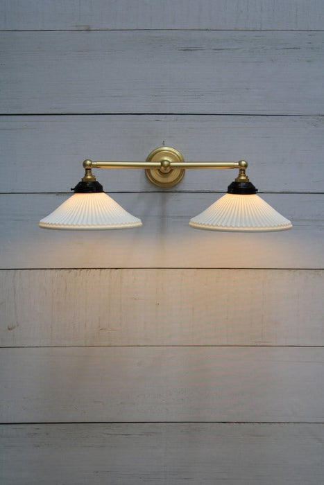 Double arm wall light with gold/brass finish and ceramic shades