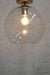 Round glass ceiling light with gold ceiling rose'