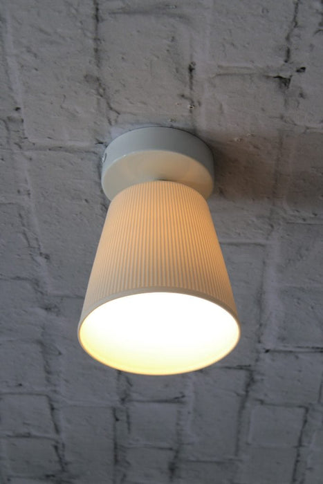 Ceiling light with white base and large ceramic shade