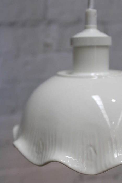 Frilled ceramic pendant with white cord