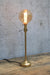 Gold candlestick table lamp with amber bulb
