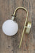 Opal glass shade and gold wall sconce