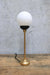Gold steel candlestick lamp with opal shade unlit