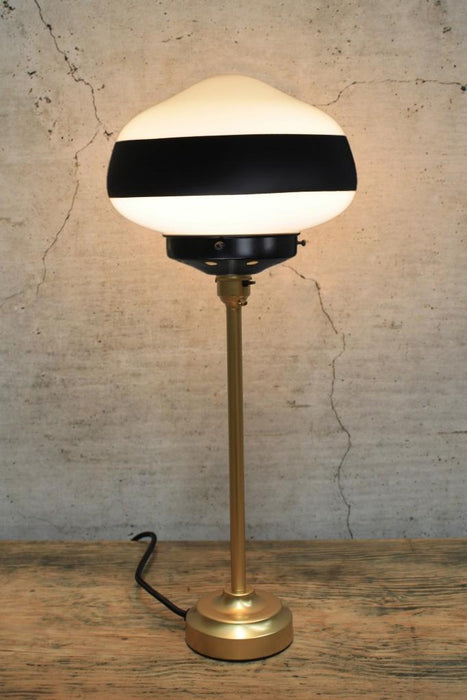 Gold base table lamp with one stripe shade