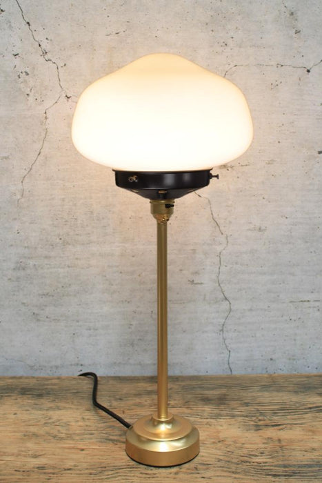 Gold base table lamp with plain opal shade