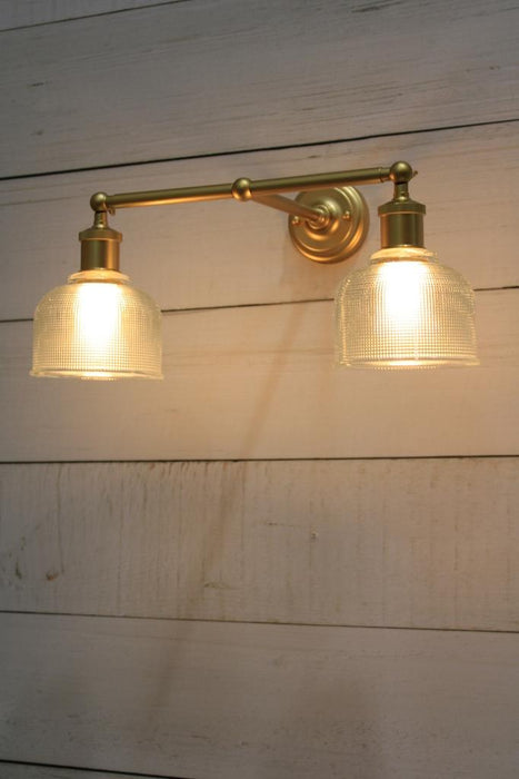 Gold wall light with two holophane glass shades
