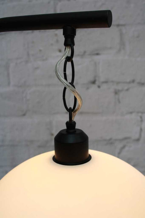 chain suspension holding up glass shade