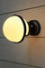Huxley ceiling light on wall in black finish with opal shade