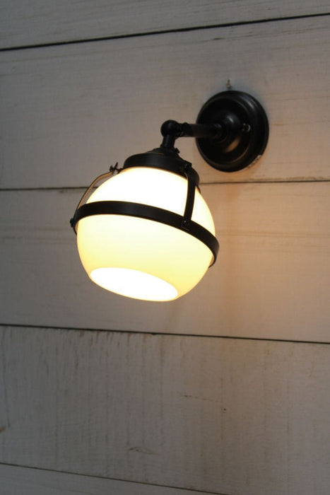 Huxley wall light with short black arm and small open opal shade