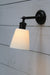 Swivel arm wall light with black sconce and large ceramic shade