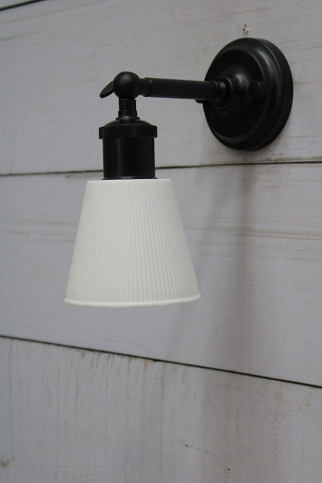 Black wall light with small white ceramic shade