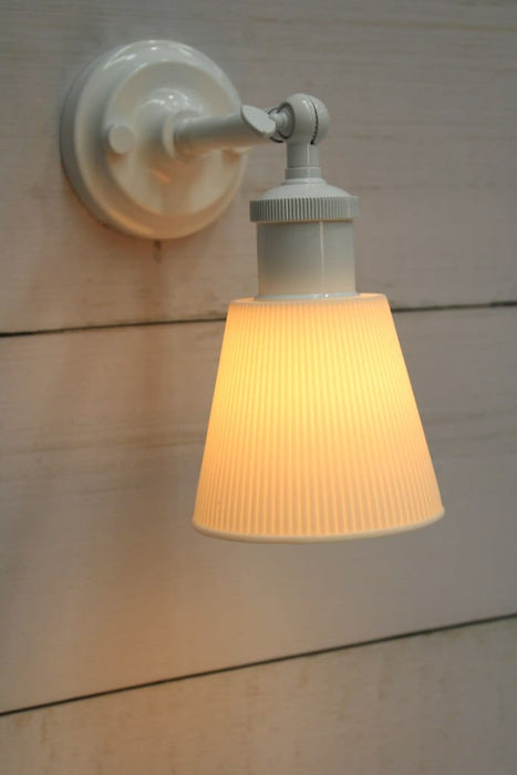 White wall light with small ceramic shade