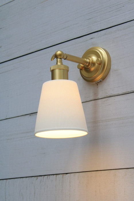 Gold/brass swivel wall light with a large ceramic shade