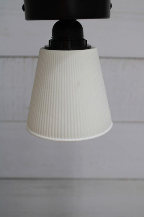 Ceiling light with black base and small ceramic shade