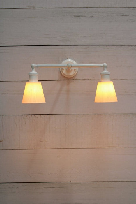 Ceramic shade with double swivel arm in white finish.