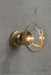Huxley ceiling light on wall in gold finish with small clear shade