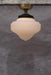 Small milky glass shade with gold/brass batten holder.