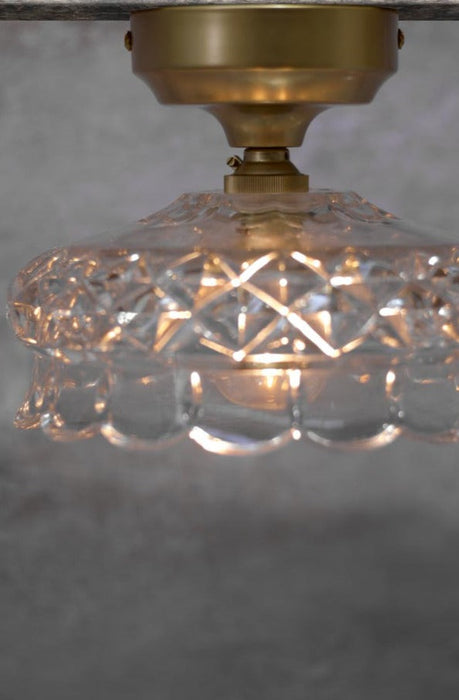 close up of Apsley Glass Ceiling Light with gold/brass batten holder.