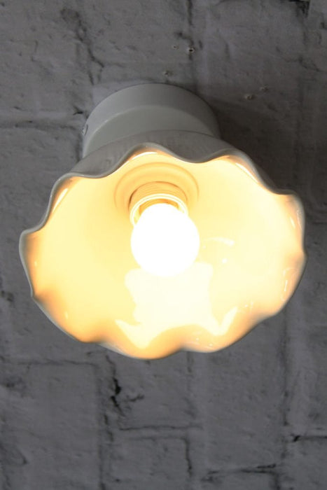 Close-up of ceramic light flush mounted on brick wall. 