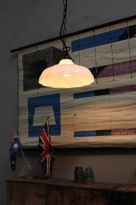 The milky glass shade s design quietly blends with the chain saw suspension tooth ceiling chain.