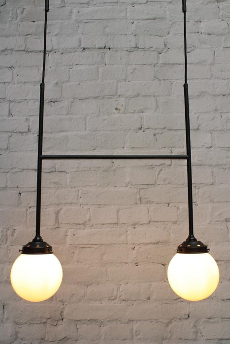 Configuration B junction pendant light with black finish and two opal glass ball shades