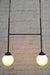 Configuration B junction pendant light with black finish and two opal glass ball shades