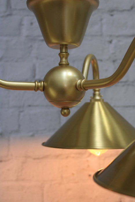 Industrial flush mount light in gold finish close up on centrepiece