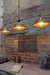 Industrial brass three light pendant with cage guards