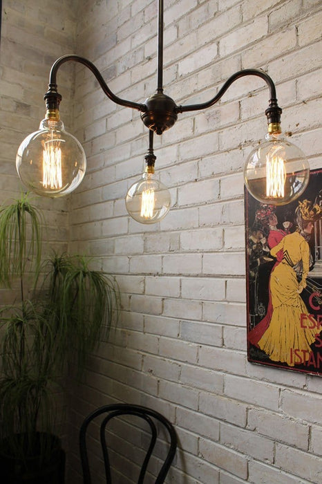 Industrial gooseneck chandelier in cafe restaurant or over dining table