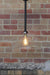 Industrial lab funnel rod pendant light has a large glass funnel shade.