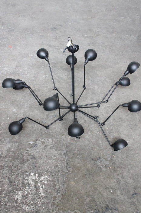 Industrial spider chandelier has 12 arms and shades to illuminate a large interior setting