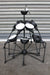 Industrial spider chandelier has a matt black body and white inner shades