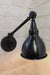 Industrial swing arm wall lamp with black enamel shade and arm