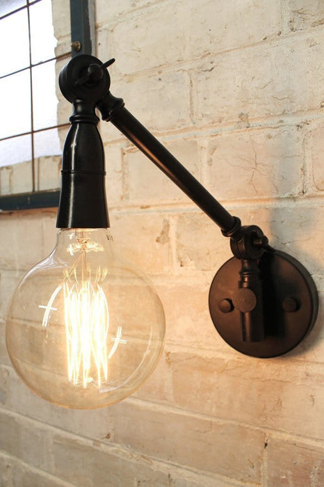 Industrial swing arm wall light with x large squirrel cage edison bulb