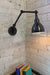 Industrial two arm swing wall lamp is great for task lighting