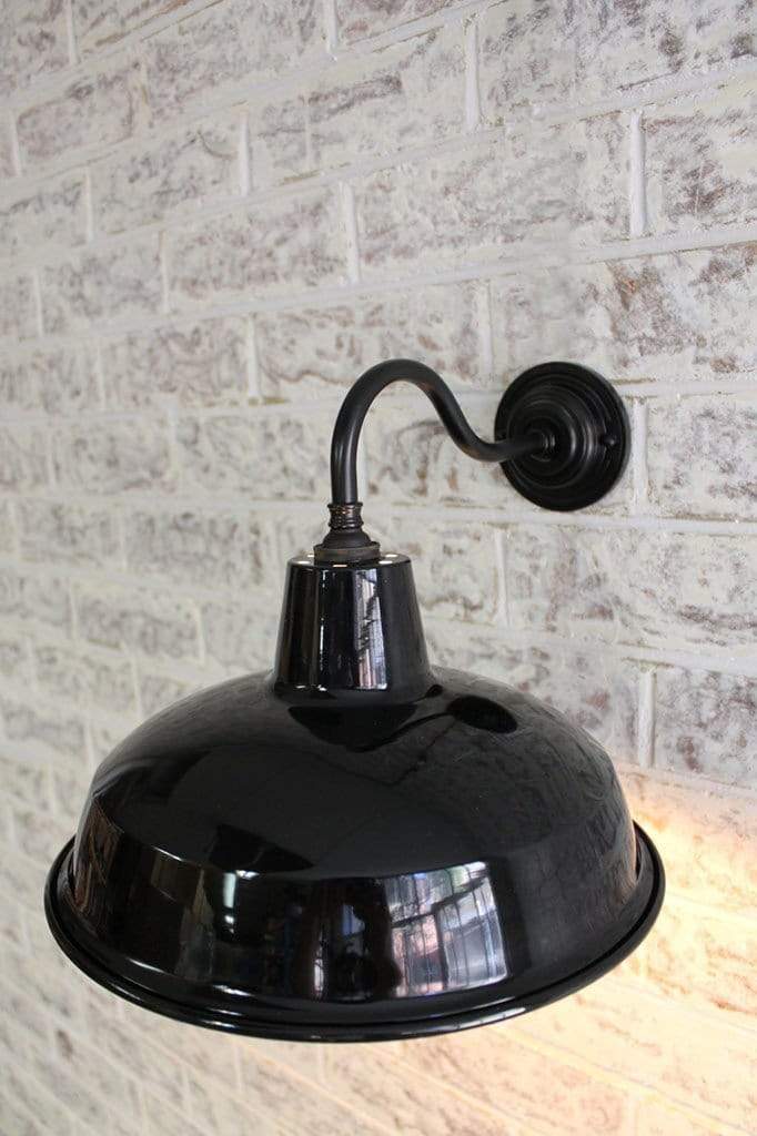 Industrial warehouse gooseneck wall light on bare brick wall