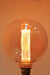 Round amber bulb with laser-cut filament