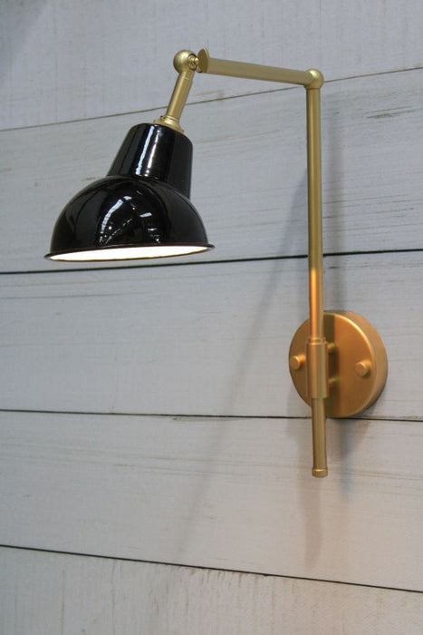 Gold/brass wall sconce with black and white shade